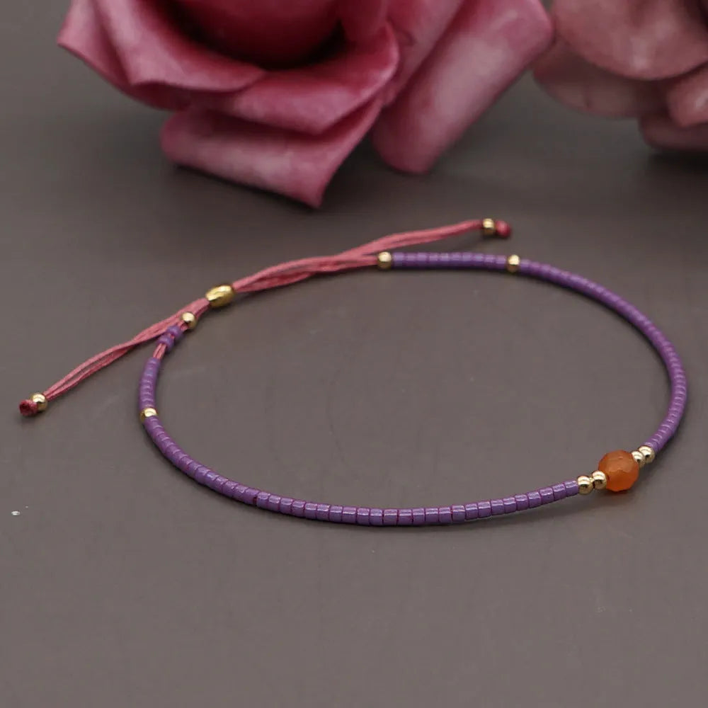 Handmade women's colourful beaded bracelet with geometric glass beads in bohemian style