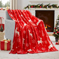 Soft plush red Christmas blanket draped over a grey sofa.