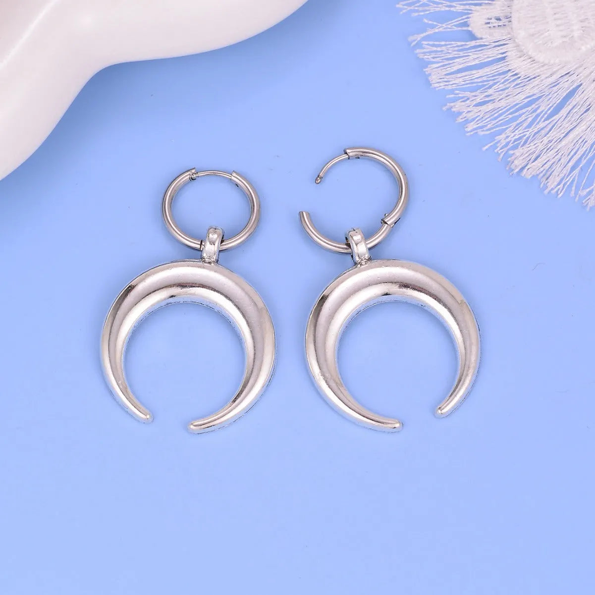 Silver geometric hoop earrings with moon detail and clip-on back