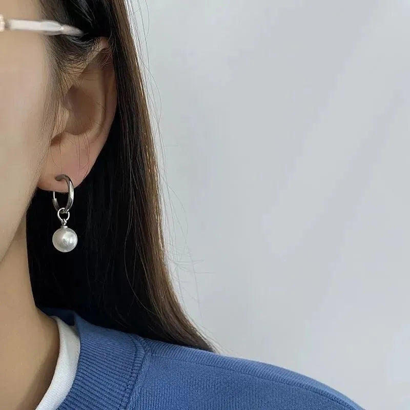 Geometric pearl hoop earrings with circular design and titanium steel alloy construction
