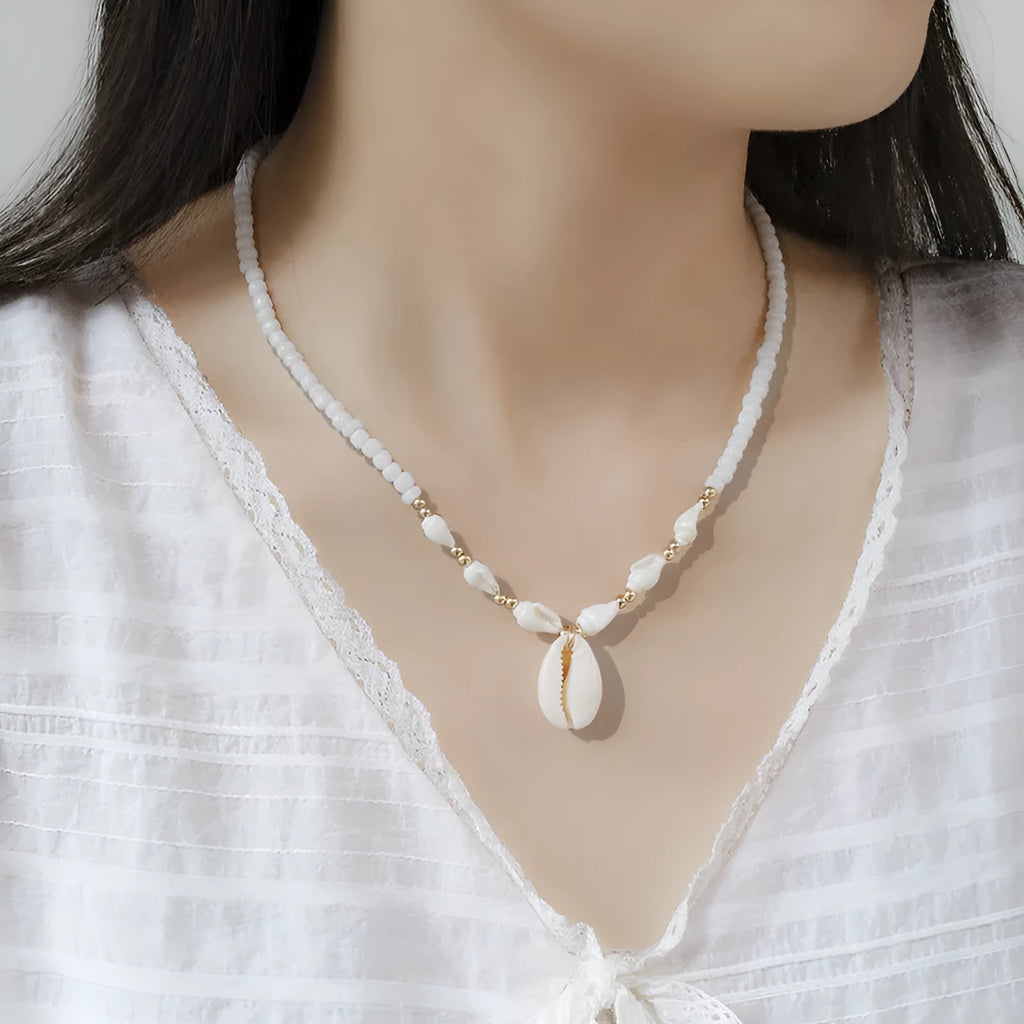 White conch shell necklace with mother-of-pearl pendant on electroplated chain with bead accents