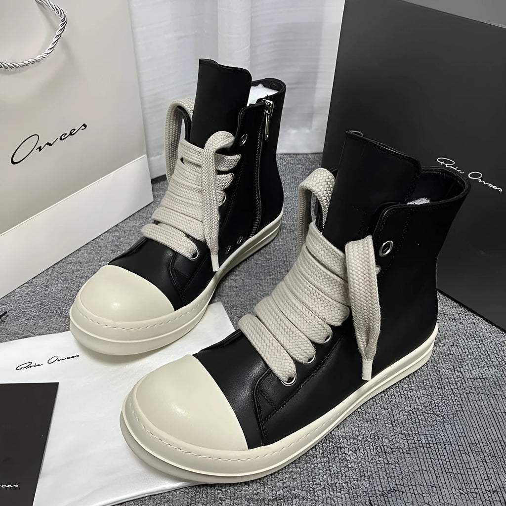 Black leather high-top sneakers with side zipper and round toe on a rubber platform sole