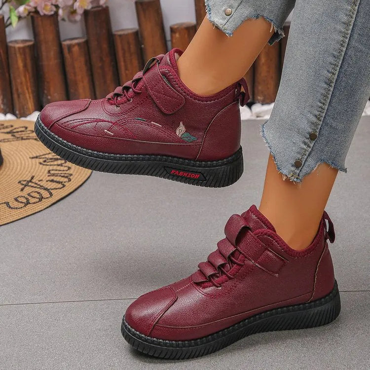Women's black velvet house shoes with non-slip rubber sole and low tube socks design.