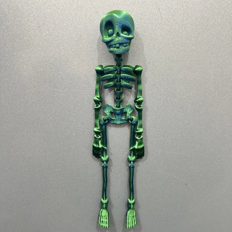 3D printed white skull refrigerator magnet with intricate details on a metallic surface.