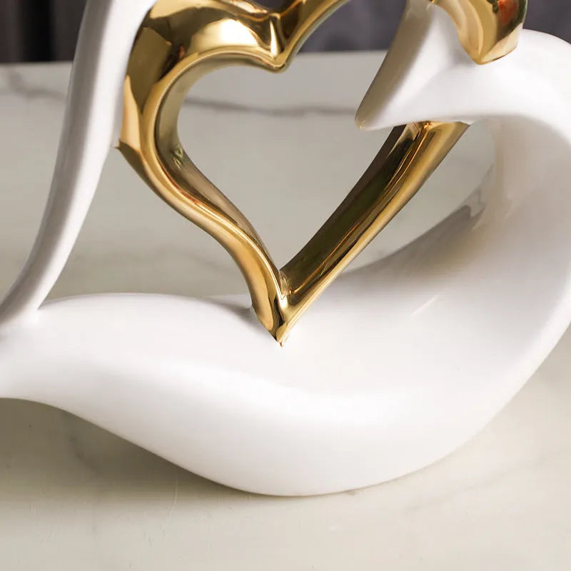Modern geometric heart ornament in metallic finish displayed on shelf