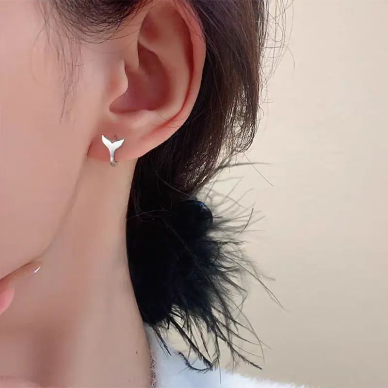 Women's fishtail design earrings in electroplated copper with gold colour finishes
