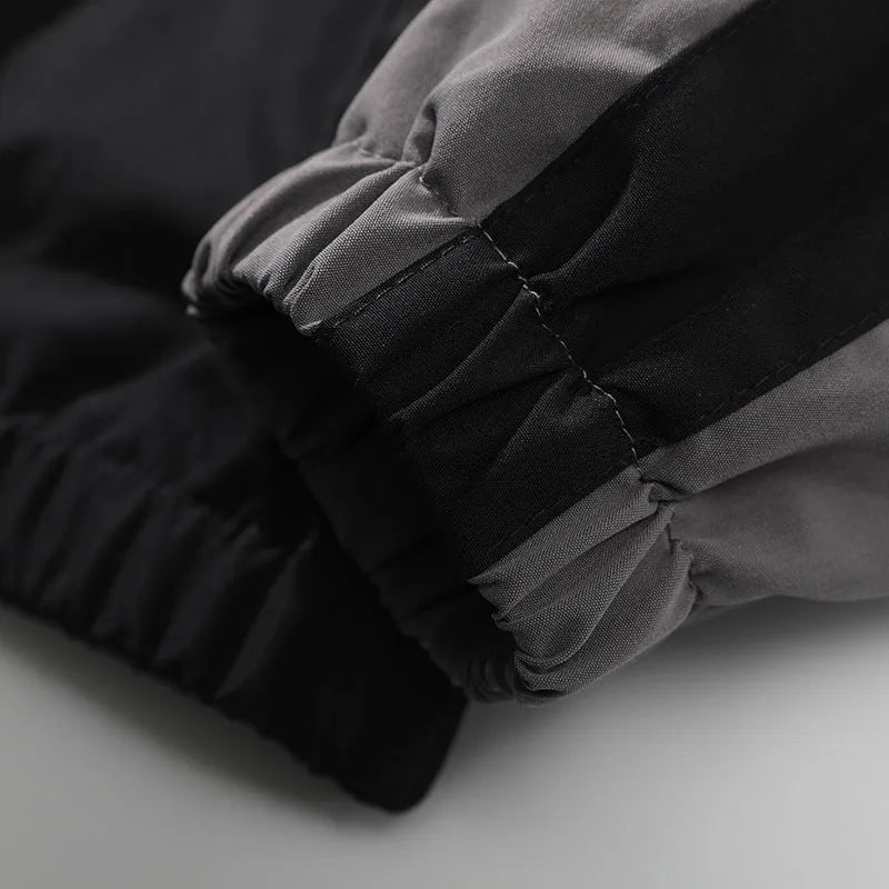 Men's black casual jacket with contrast stitching and side seam pockets, shown on a model.