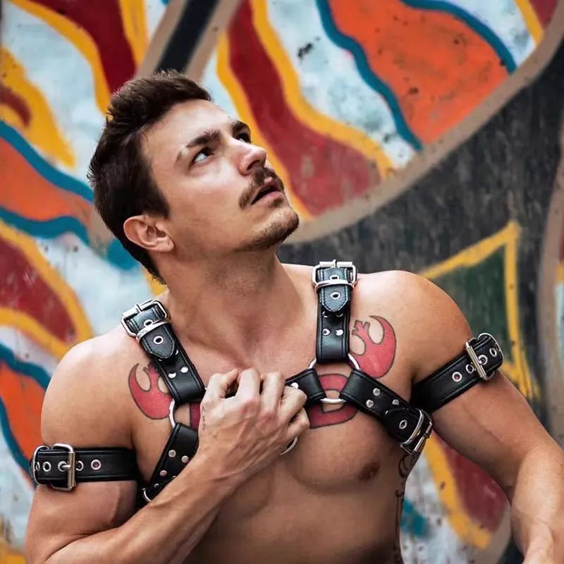 Men's black leather chest muscle bondage strap with metal buckles and adjustable shoulder harness design