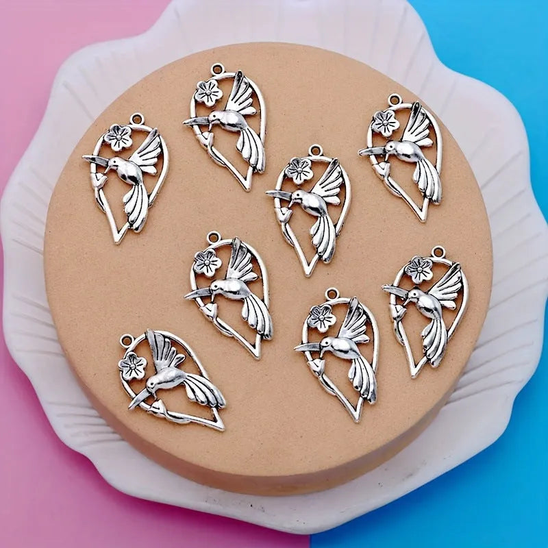 Gold-tone alloy magpie pendant charm for DIY jewellery making on a white background.
