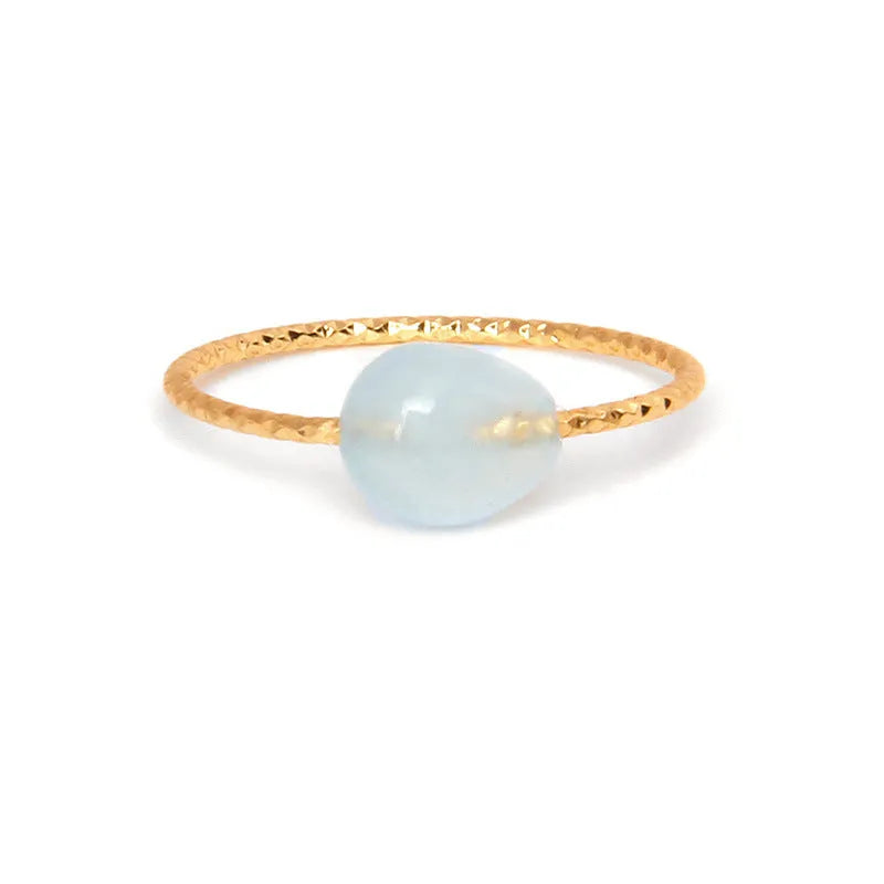 Original geometric design women's ring in coloured agate stone on a plain background.