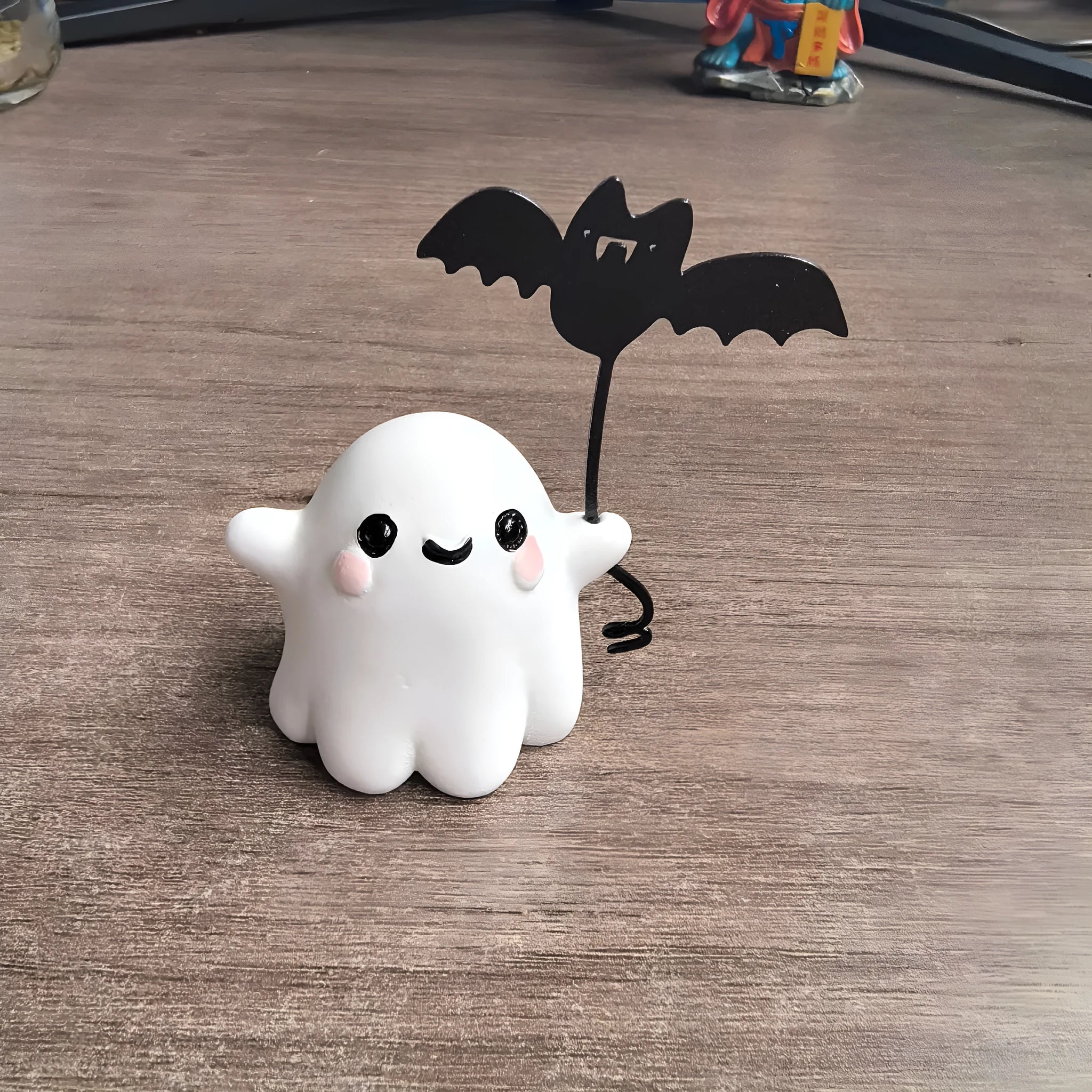 Mini resin statue of a white ghost walking a black bat, Halloween decoration