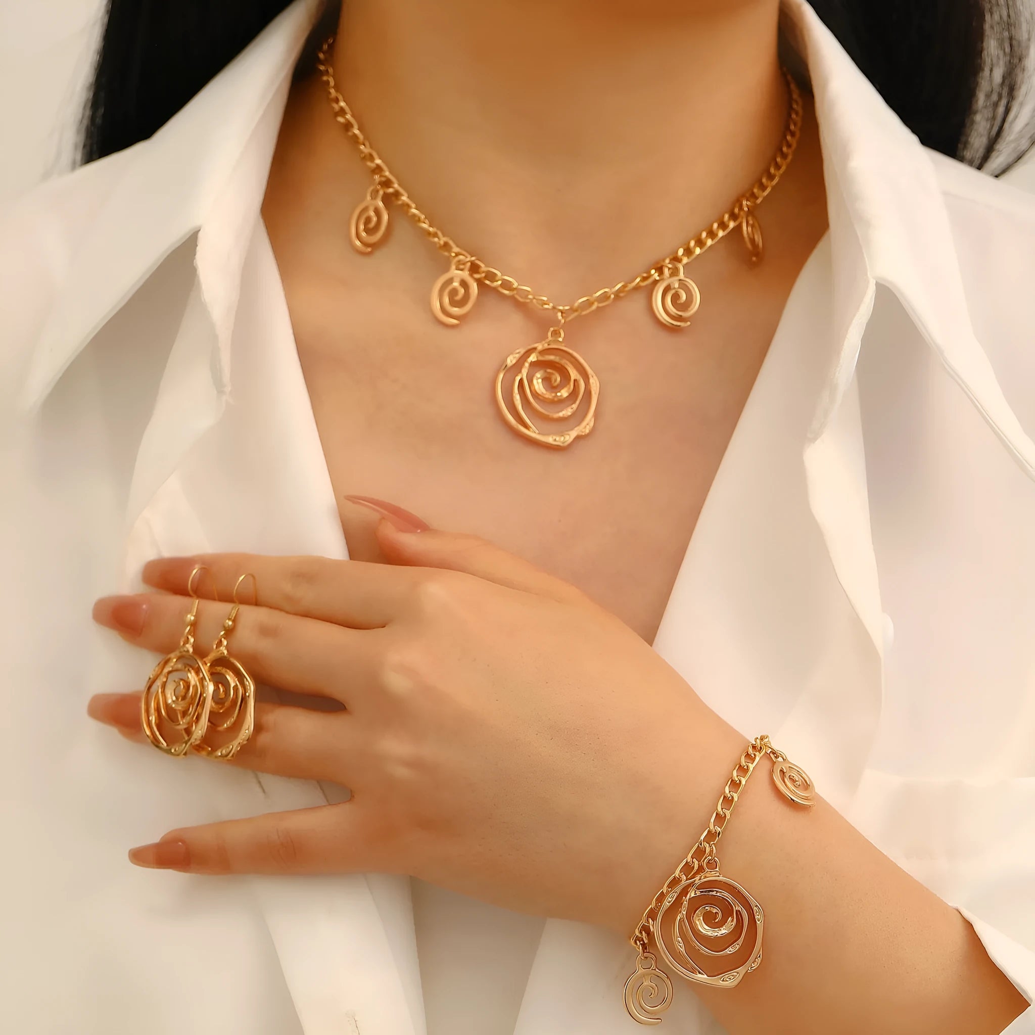 Spiral donut geometric jewellery set with necklace, bracelet, and earrings in gold electroplate