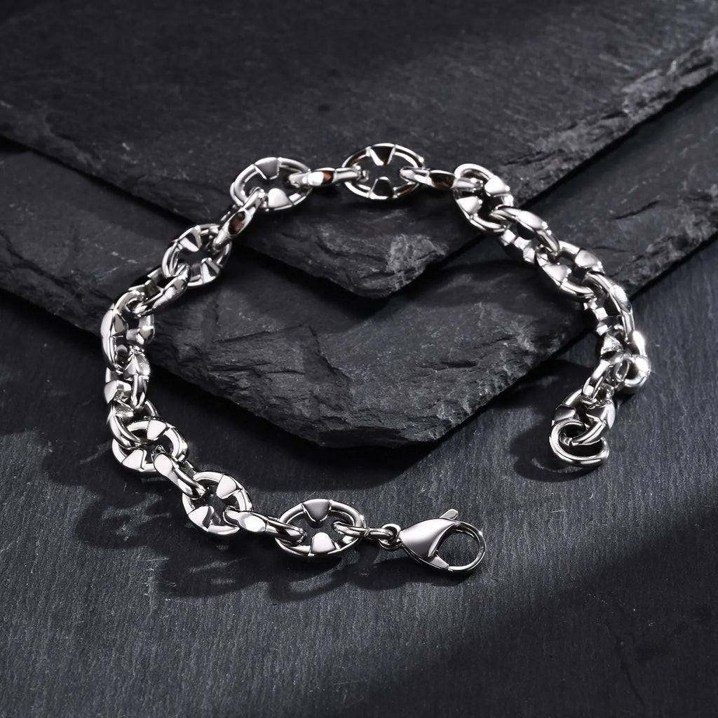 A thick handmade stainless steel bracelet with a geometric shape and steel colour finish.