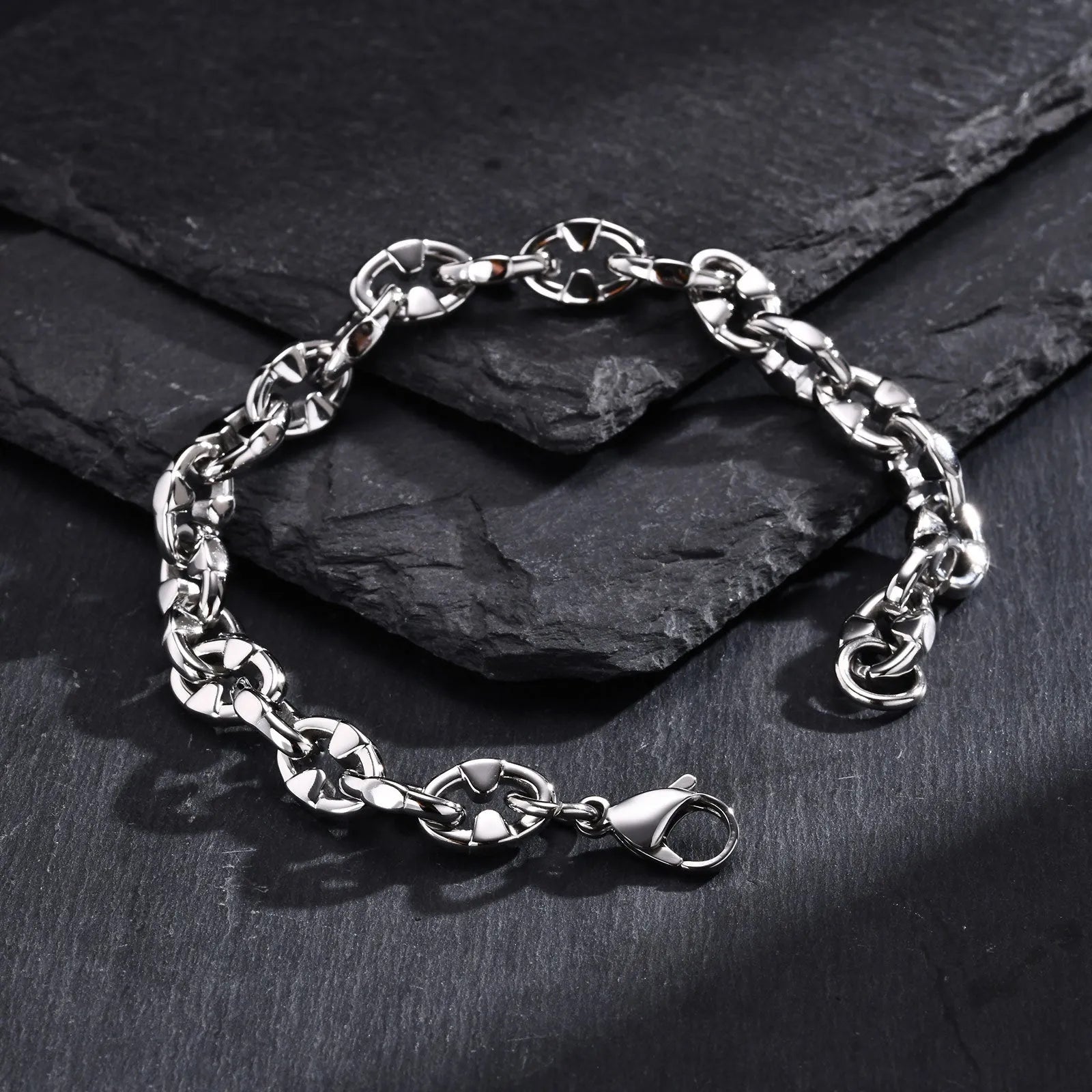 A thick handmade stainless steel bracelet with a geometric shape and steel colour finish.