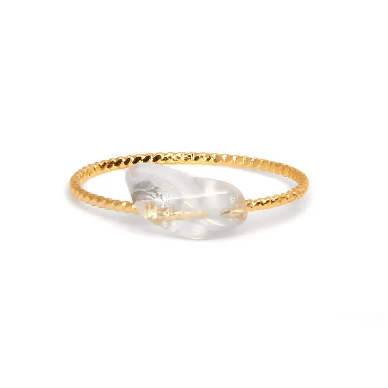 Original geometric design women's ring in coloured agate stone on a plain background.