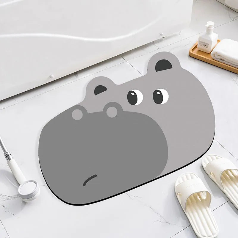 Cartoon animal diatomite absorbent bathroom mat in alien shape on bathroom floor.