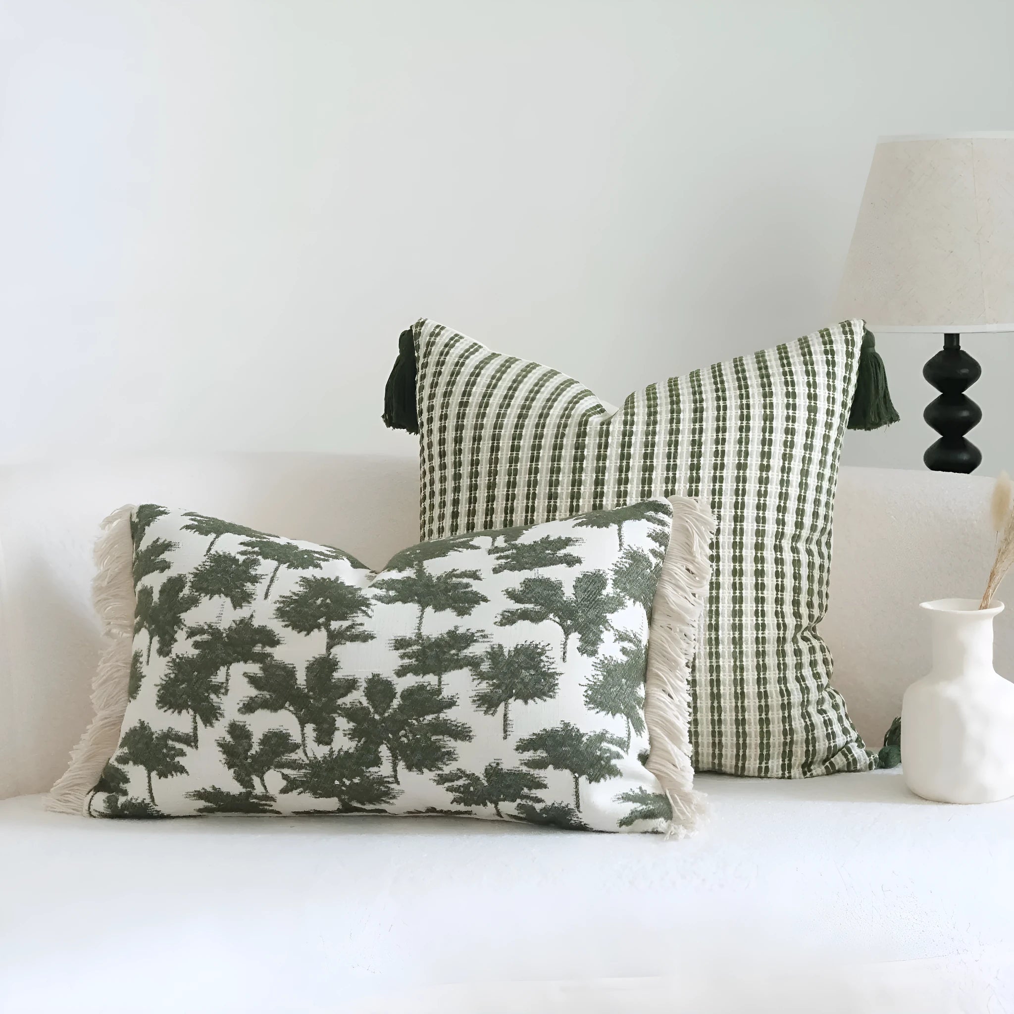 Green cotton and linen hotel sample pillow with tassel or beaded trim, shown in one of three pattern options.
