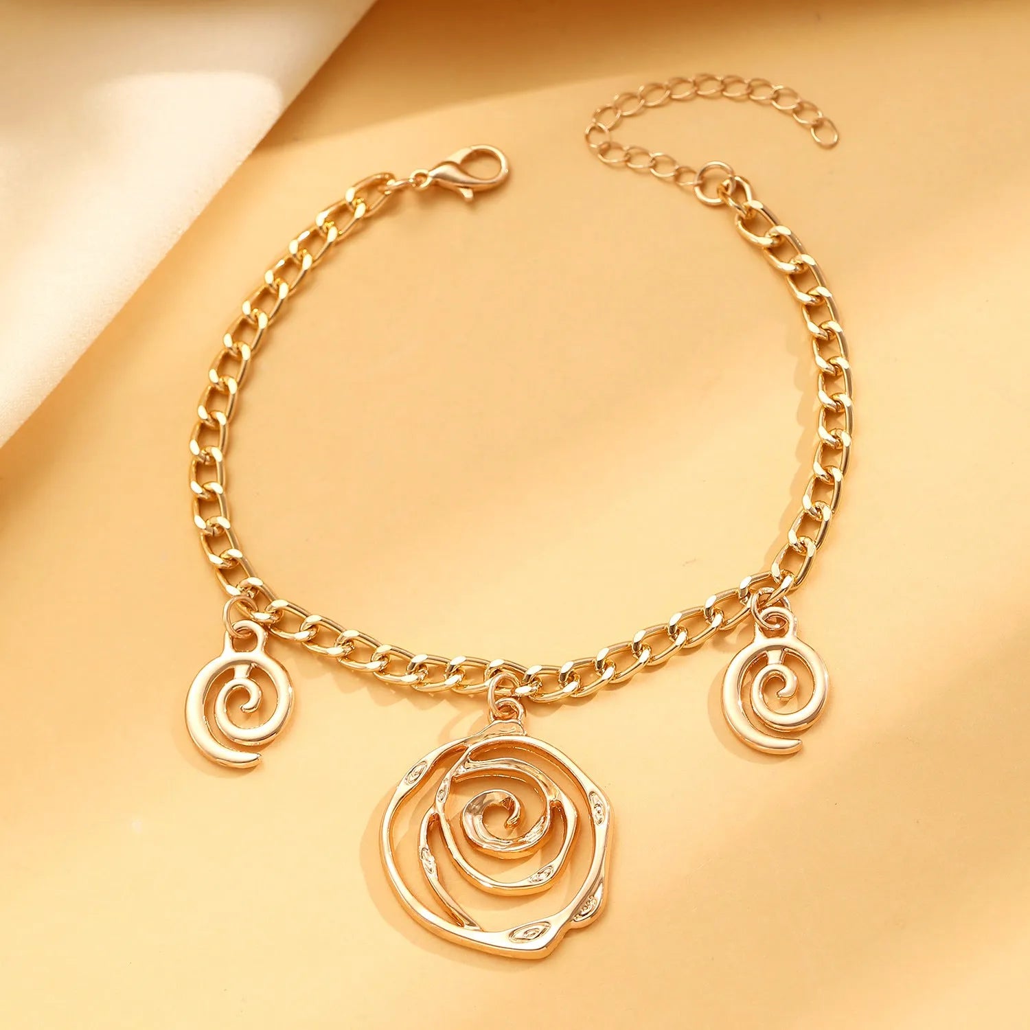 Spiral donut geometric jewellery set with necklace, bracelet, and earrings in gold electroplate