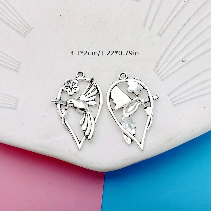 Gold-tone alloy magpie pendant charm for DIY jewellery making on a white background.
