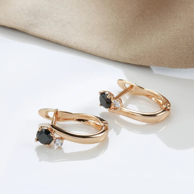Gold-coloured drop earrings with geometric black agate design and retro styling