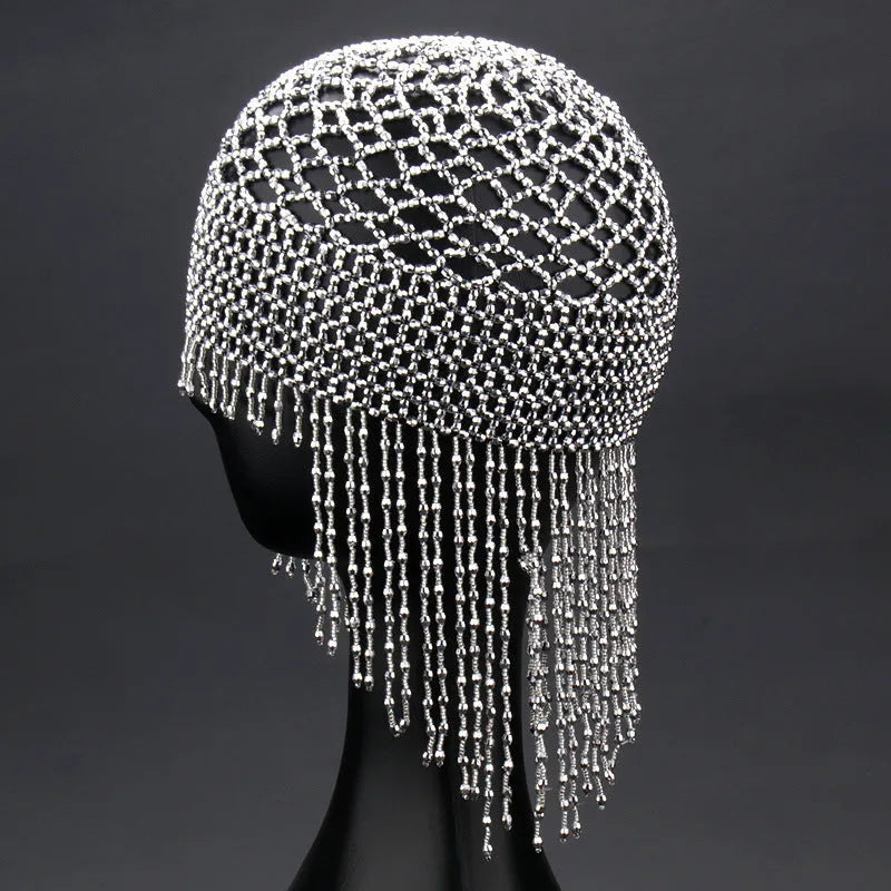Silver belly dance hat with beaded tassels on black background for performance hair ornament