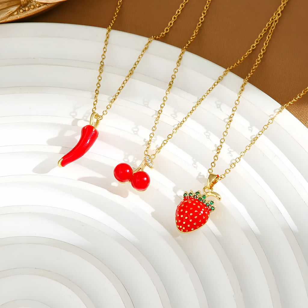 Delicate indie charm necklace with cherry, strawberry, and pepper pendants on a titanium steel chain.