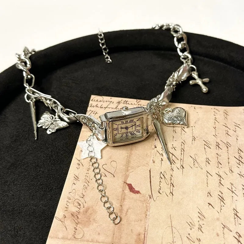 Dark multi-layer cross necklace with twin clavicle chains showing adjustable length and alloy construction