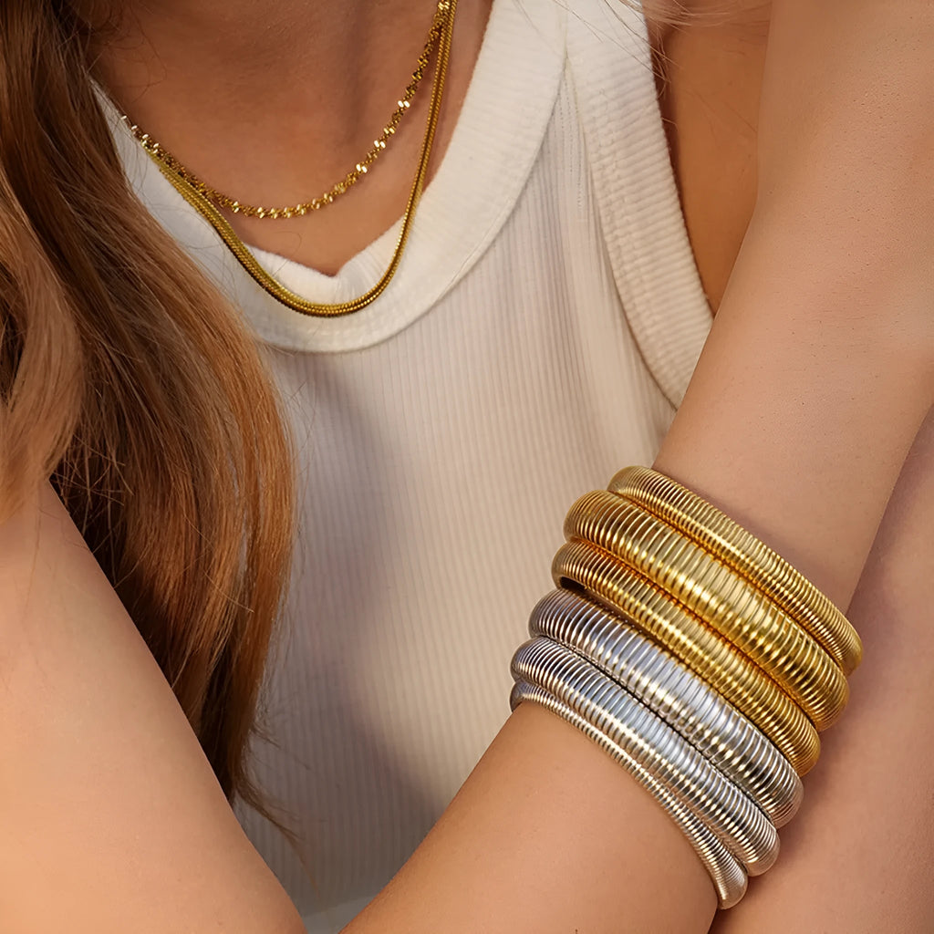 Women's titanium steel elastic bracelet with vertical stripe ring pattern in gold finish
