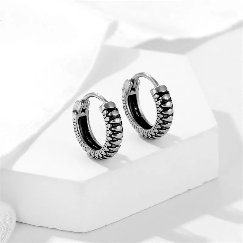 Geometric retro twist stainless steel earrings with circular sports style element in silver