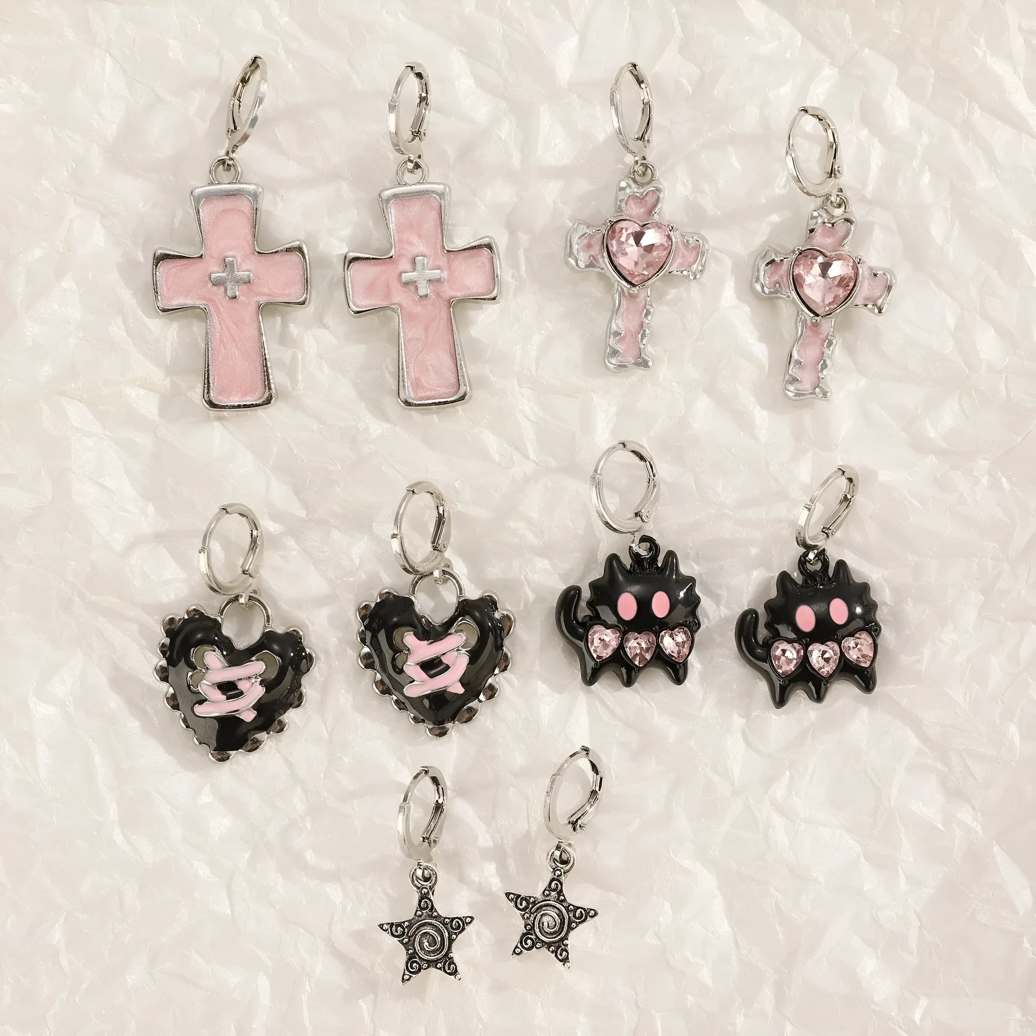 Women's classic alloy earrings with cross crystal design in five colour options on display