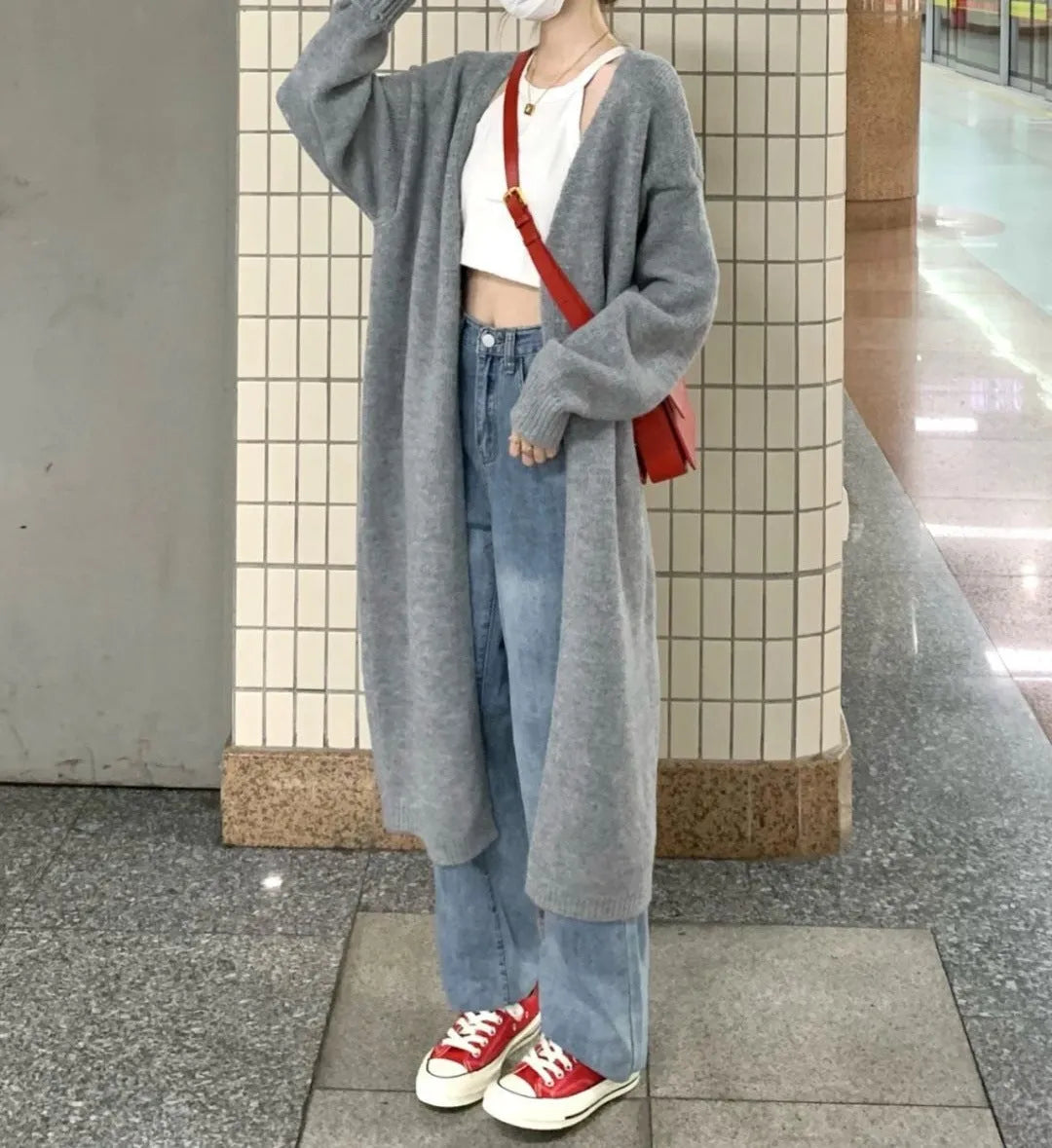 A loose, thick grey knitted women's cardigan with a 3D pattern, shown open as a cardigan.