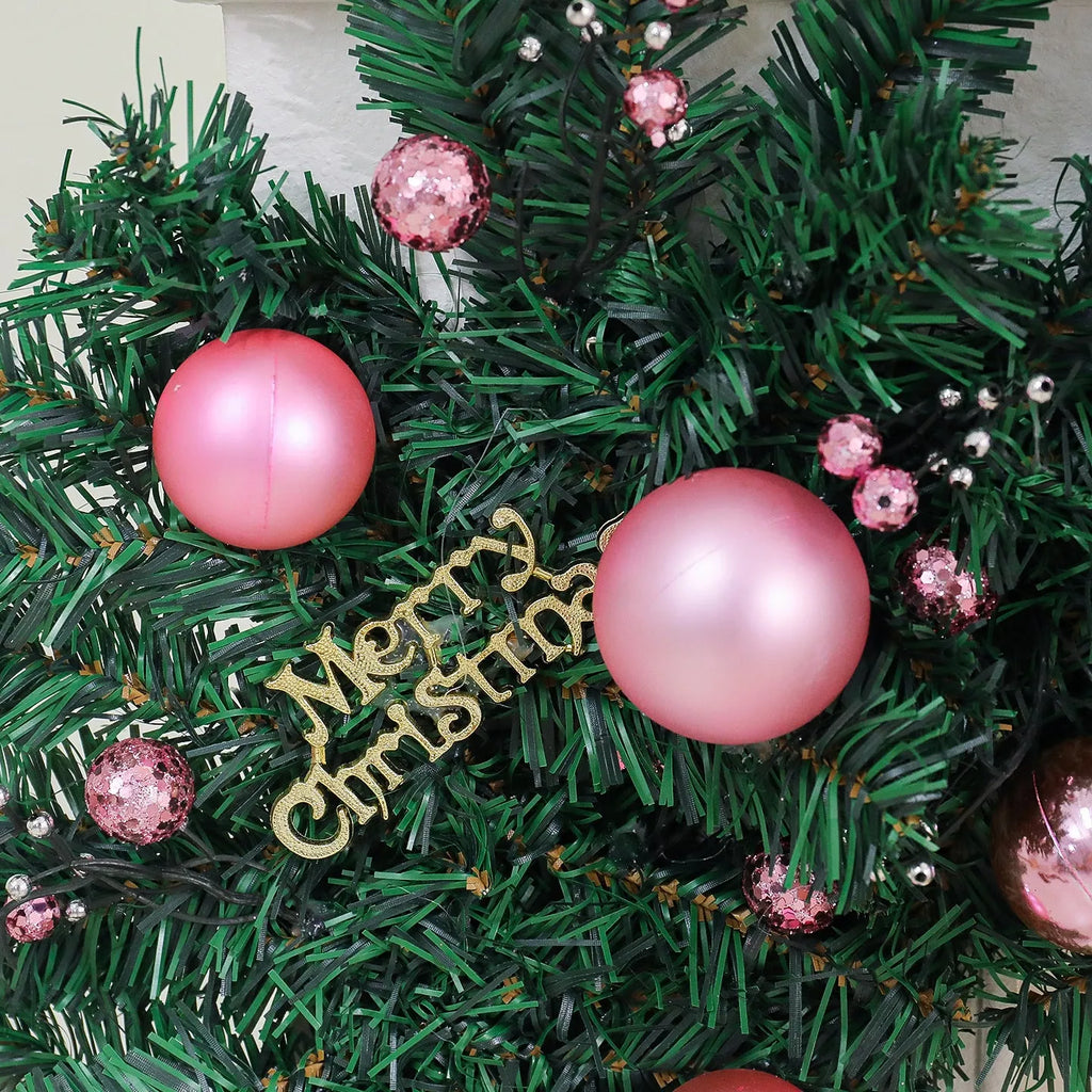 2.7 metre long pink Christmas rattan decoration with 240 decorative heads draped on a mantelpiece