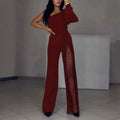 Black women's long sleeve jumpsuit with oblique shoulder neckline and high leg slit on a model.