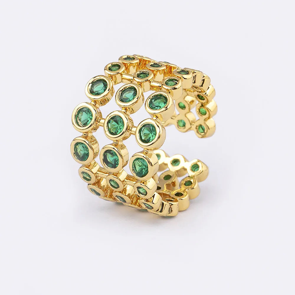 Copper ring with 18K gold plating and green zircon stones on a wide band.
