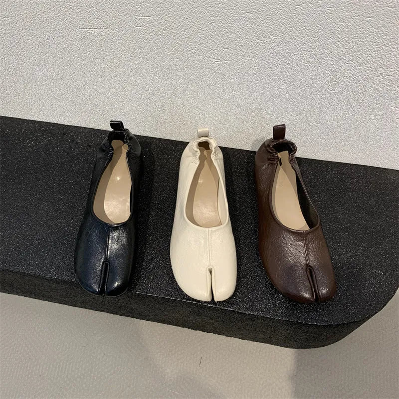 Women's apricot coloured chunky heel pumps with split toe horseshoe detail and round toe.