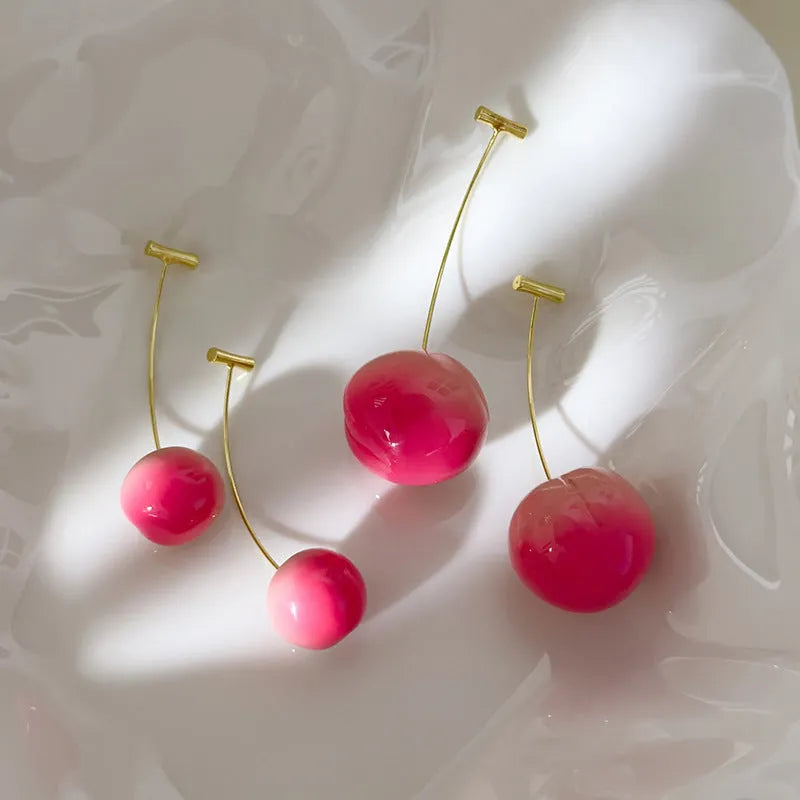 A pair of women's acrylic earrings shaped like juicy peaches, shown in small and large size options.