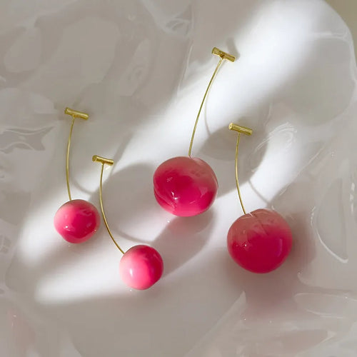 A pair of women's acrylic earrings shaped like juicy peaches, shown in small and large size options.