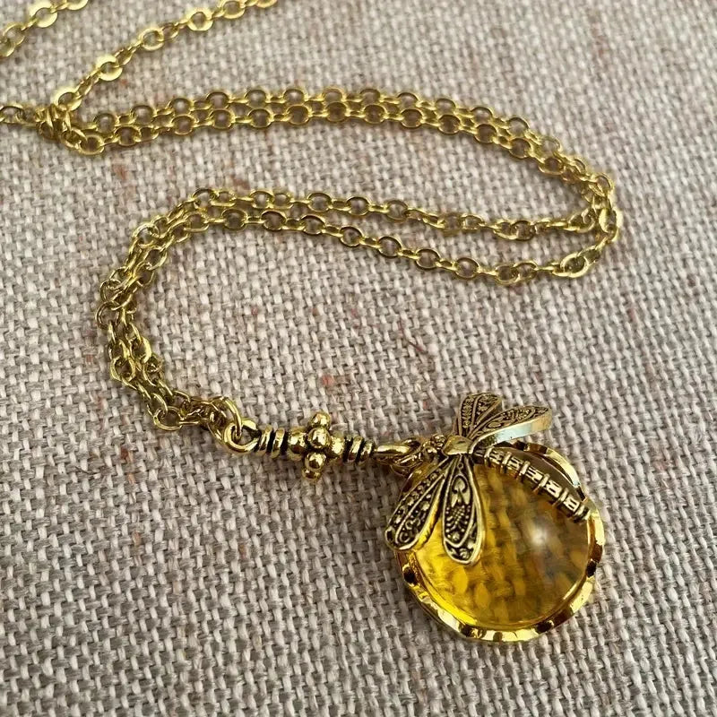 Yellow vintage bronze dragonfly pendant necklace on silver chain