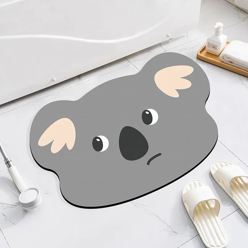 Cartoon animal diatomite absorbent bathroom mat in alien shape on bathroom floor.