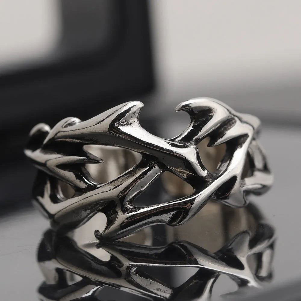 Copper men's ring with geometric thorn and flower design and adjustable band.