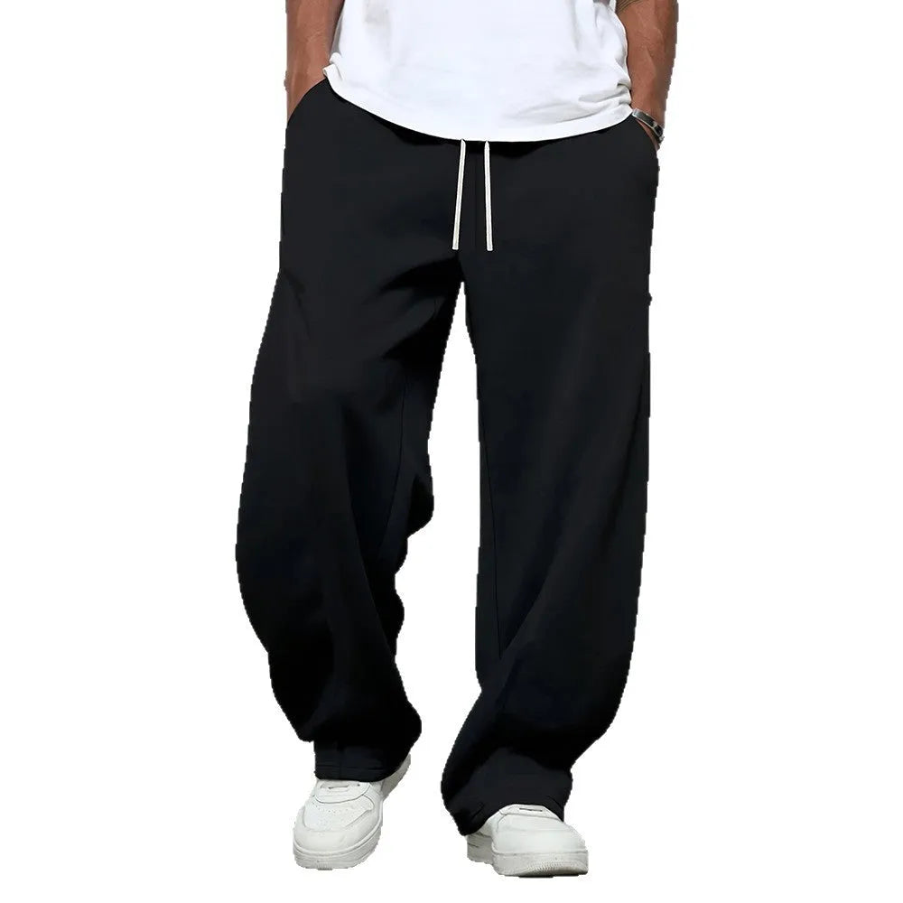Men's solid colour polyester trousers with straight leg and drawstring waist in black, dark grey, light grey