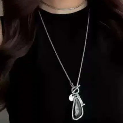 Women's long geometric pendant necklace with plaid pattern on a snake bones chain.