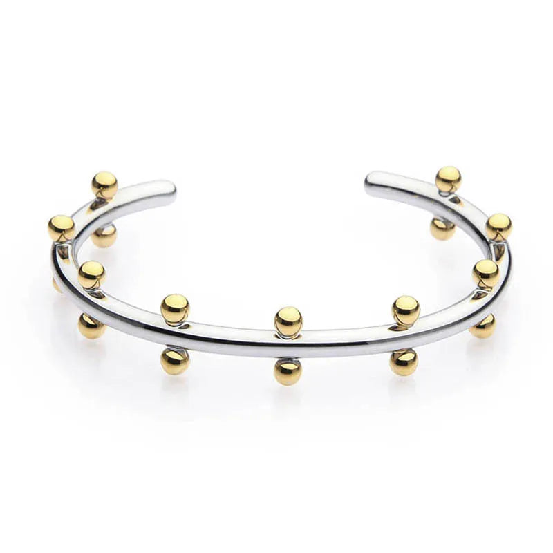 Stainless steel C-shaped bracelet with textured bean beads and rivet details in gold, steel colour, or steel colour gold finishes