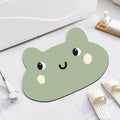 Cartoon animal diatomite absorbent bathroom mat in alien shape on bathroom floor.