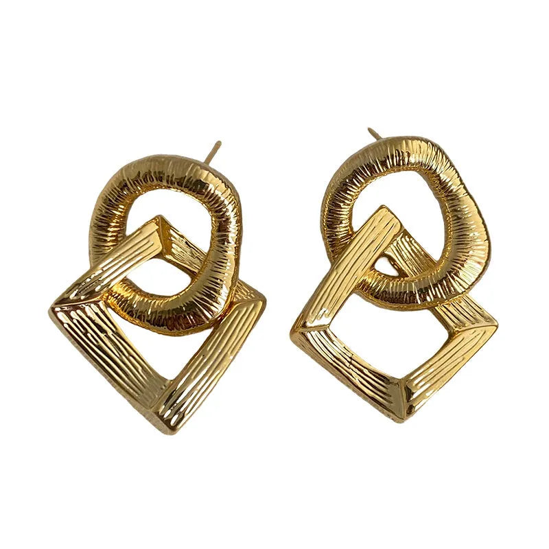 Geometric circle pendant earrings with retro styling in gold or silver electroplated colours measuring 3.4cm height