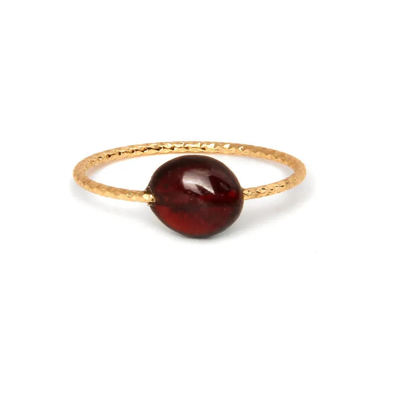 Original geometric design women's ring in coloured agate stone on a plain background.