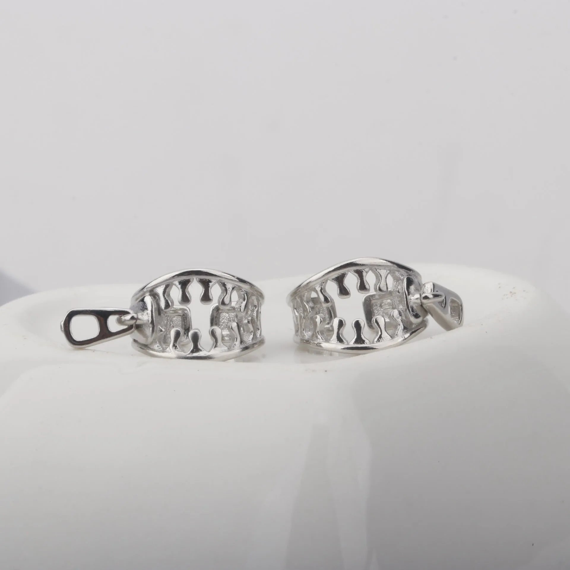 A pair of simple geometric copper clip-on earrings in colour ES862 with a linear pattern design.