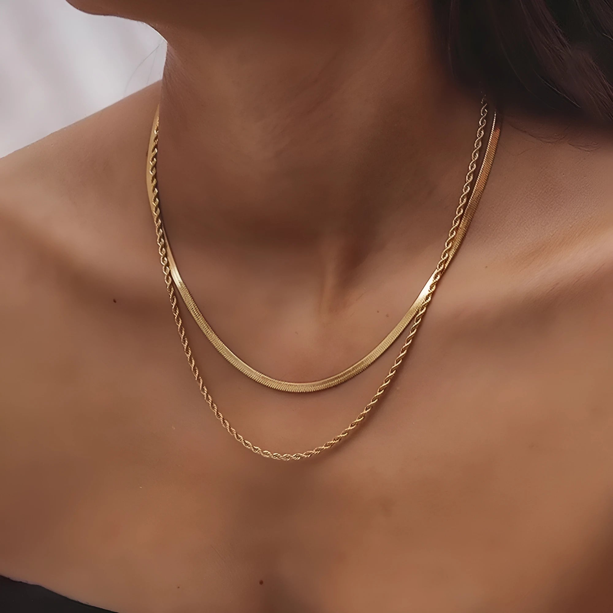 Women's silver geometric double-layer twist pendant on an adjustable snake chain necklace.