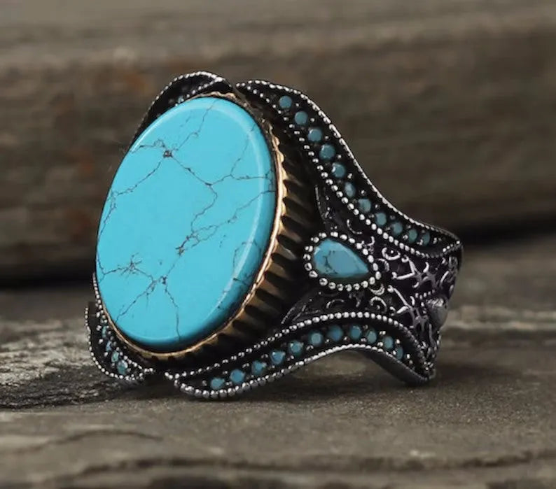 Men's antique silver turquoise alloy ring showing simple round band design on a size guide.