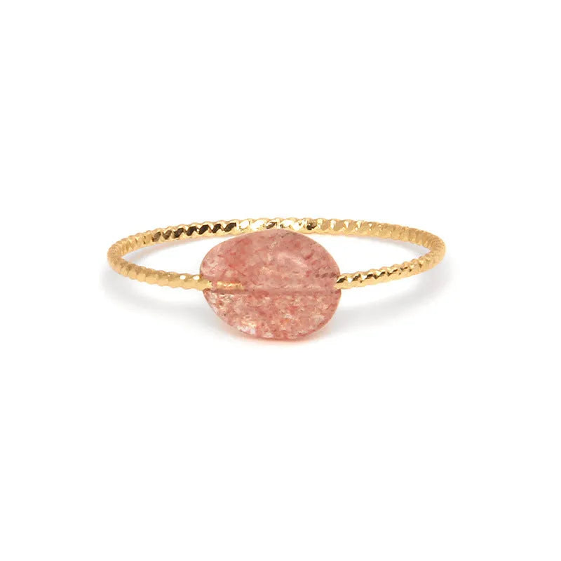 Original geometric design women's ring in coloured agate stone on a plain background.